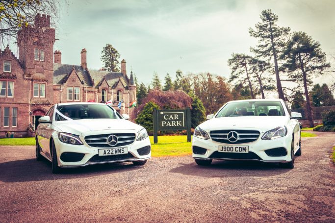 Two white wedding cars at the Newton Hotel in Nairn
